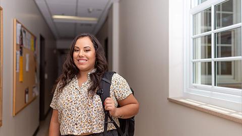 Sociology student stands in the hallways of McCord building